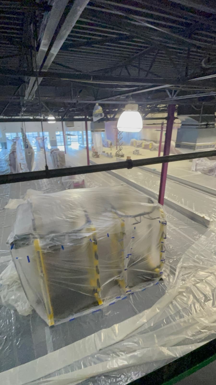Large Philadelphia commercial space under plastic containment during painting
