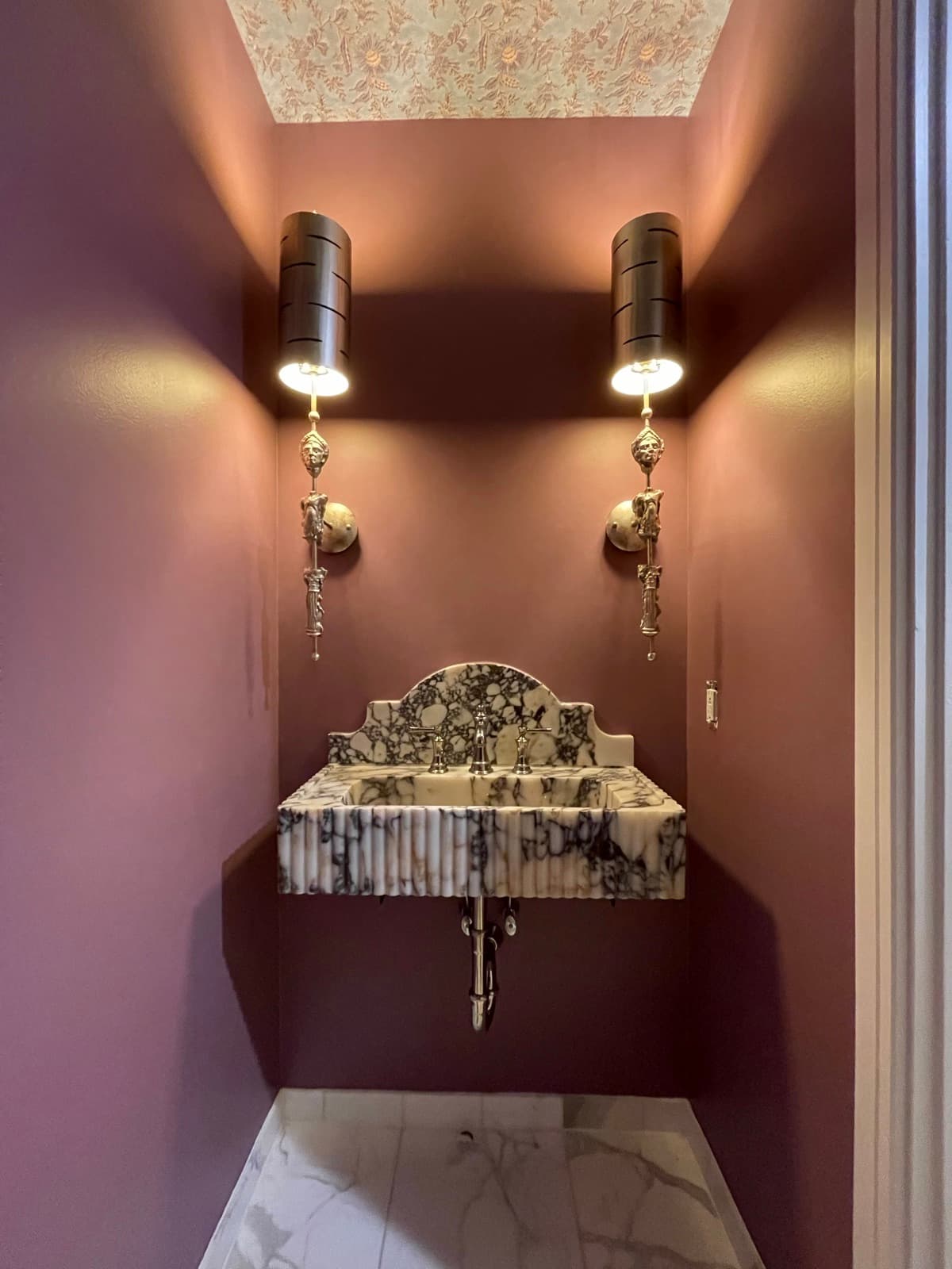 Moody plum limewash finish on the walls of a Philadelphia powder room