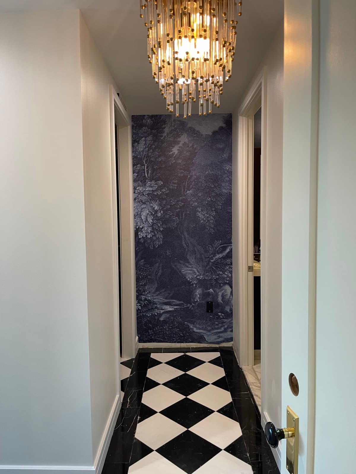 Scenic mural wallpaper and checkerboard floor in a Philadelphia hallway